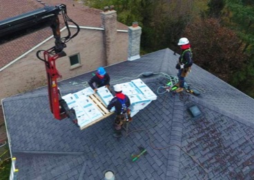 The workers replacing the rook in the house at Aurora ON
